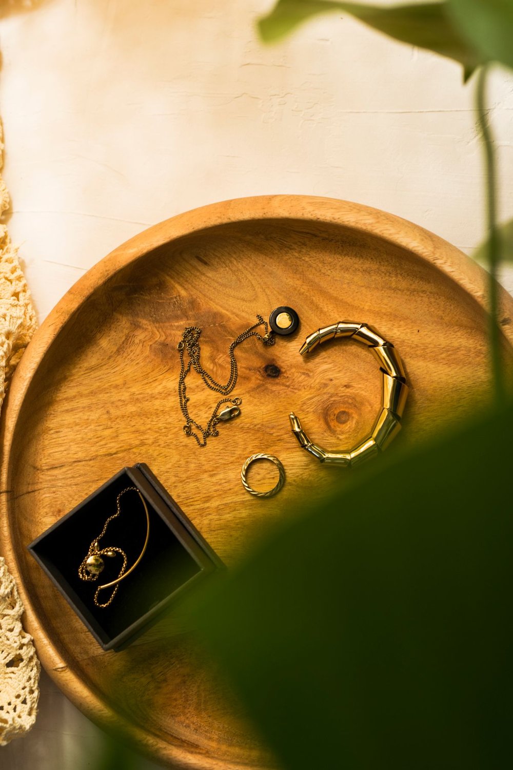 Jewellery arranged on a round wooden tray