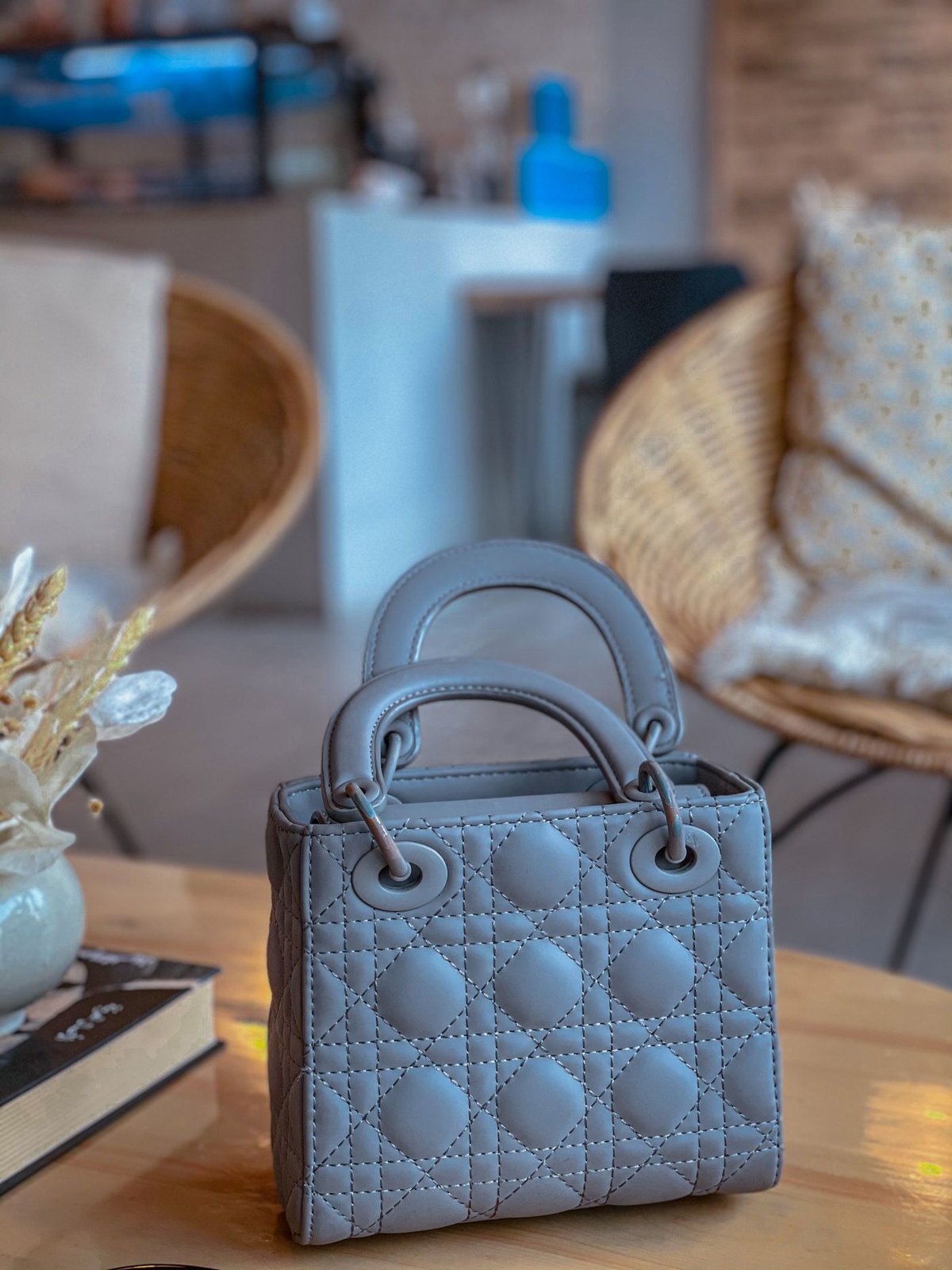 Structured grey handbag resting upright on a table