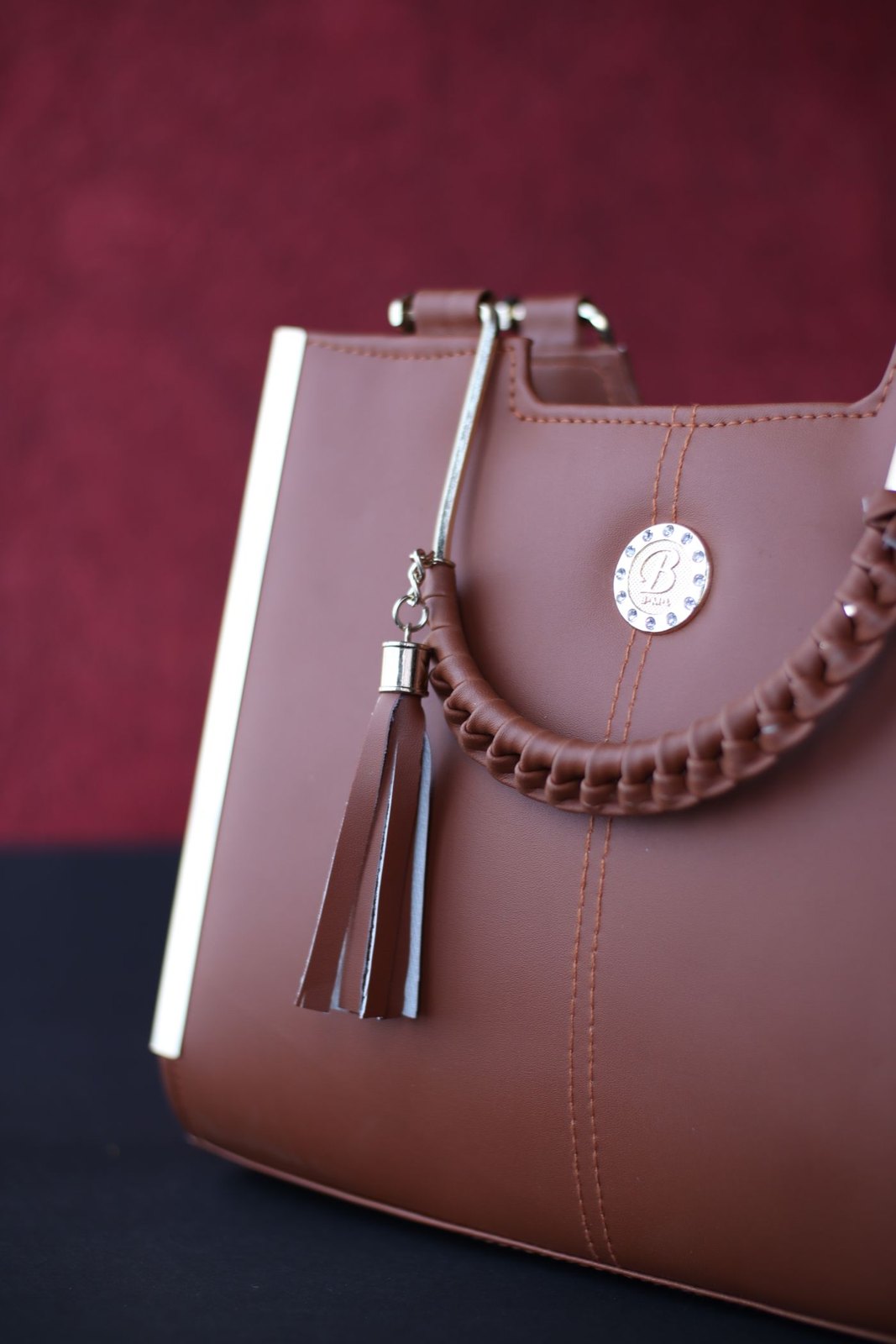 Brown structured handbag with decorative stitching