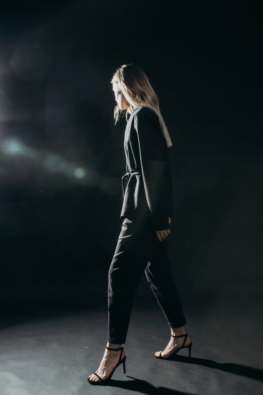 Black trousers and a black jacket in a studio outfit
