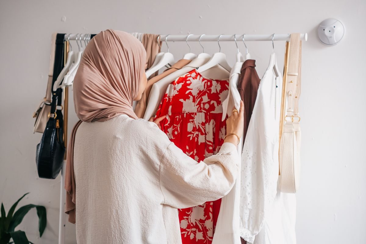 Woman looking through clothes on a rail