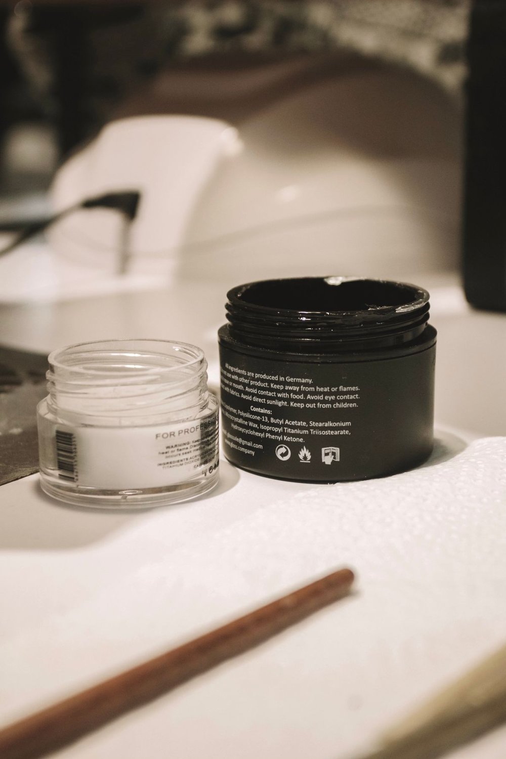 Opened cosmetic jars with their lids on a table