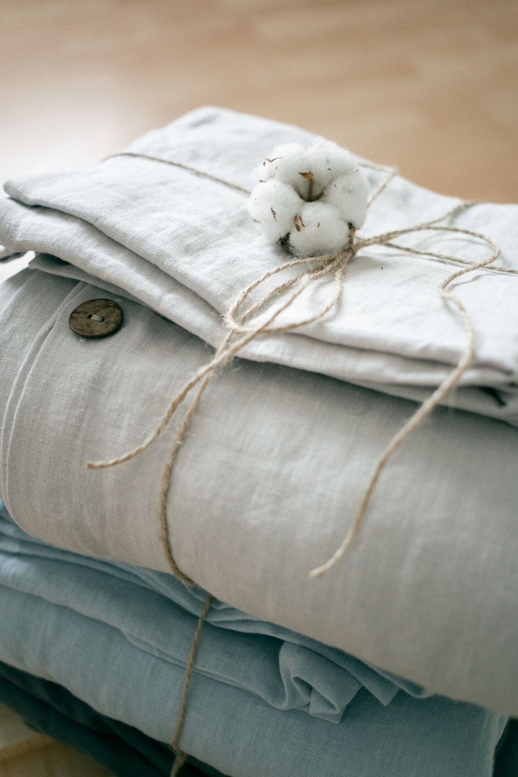 Folded pale cotton clothes with button detail