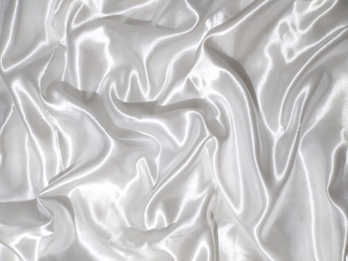 Pale silk fabric falling into soft folds