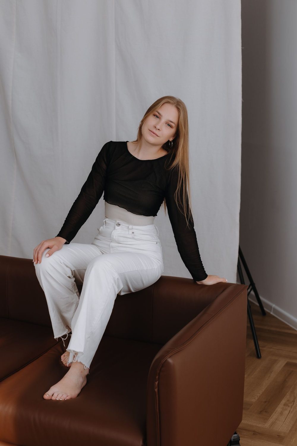 Black blouse and white trousers worn indoors
