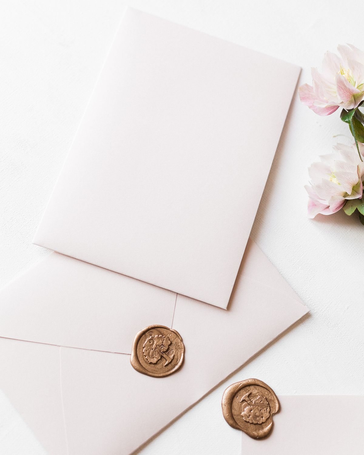 Sealed invitation envelopes with flowering branches