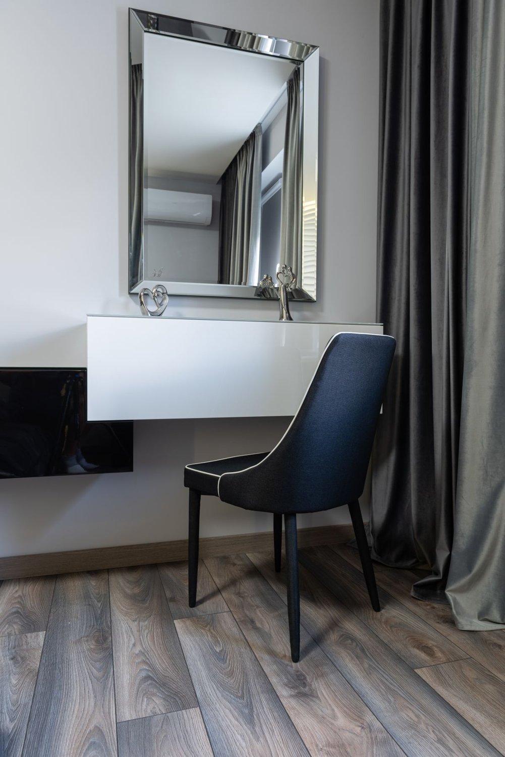 Dressing table with a square mirror and chair in a bright room
