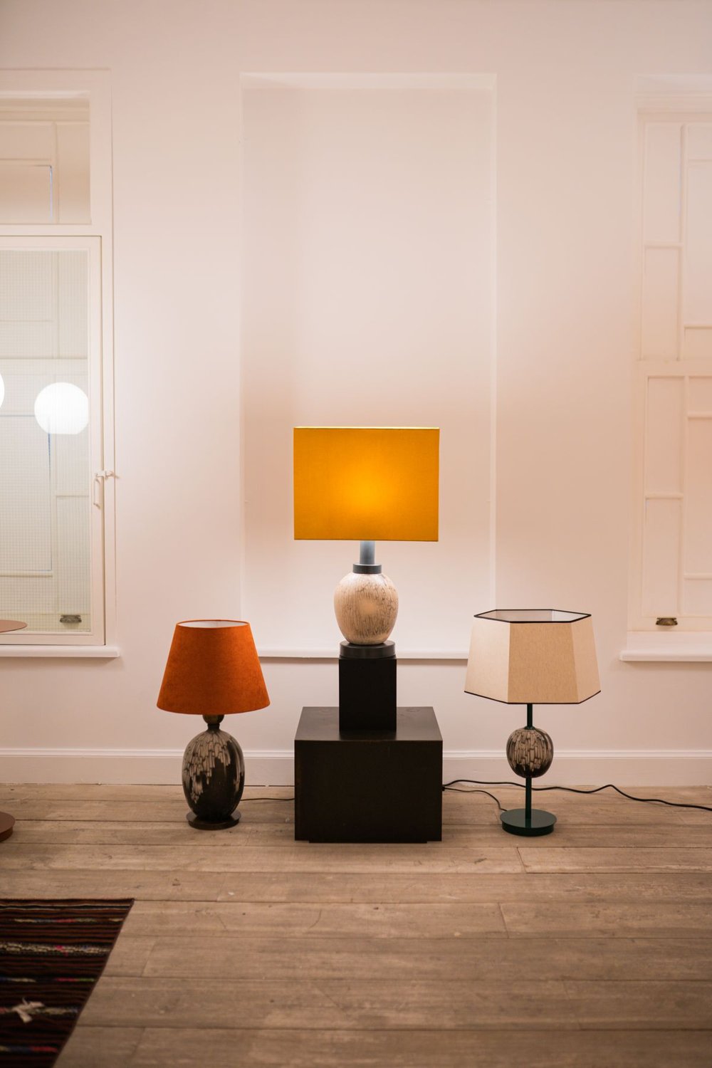 Several lamps lighting different areas of a room
