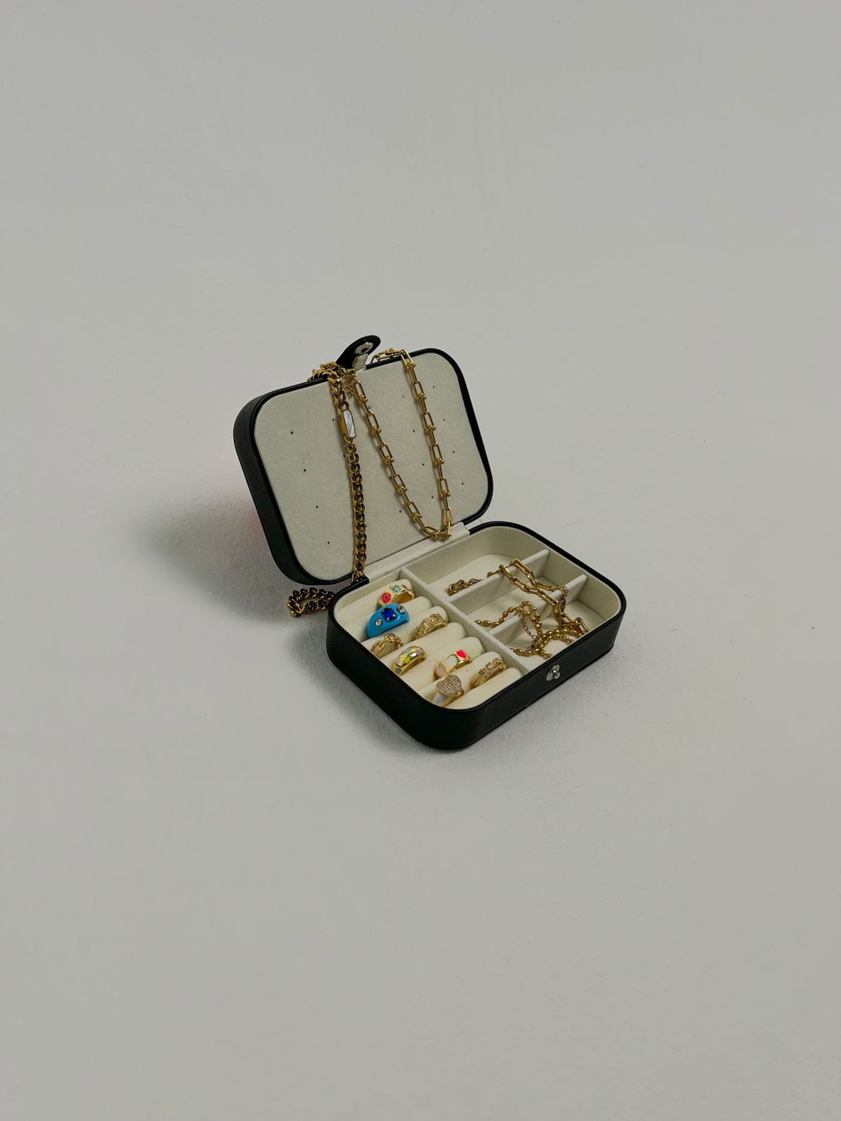 Open jewellery case containing rings and necklaces