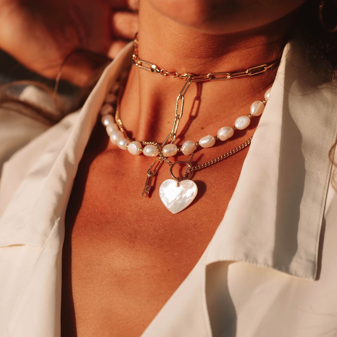 Layered necklaces with pendants at different heights
