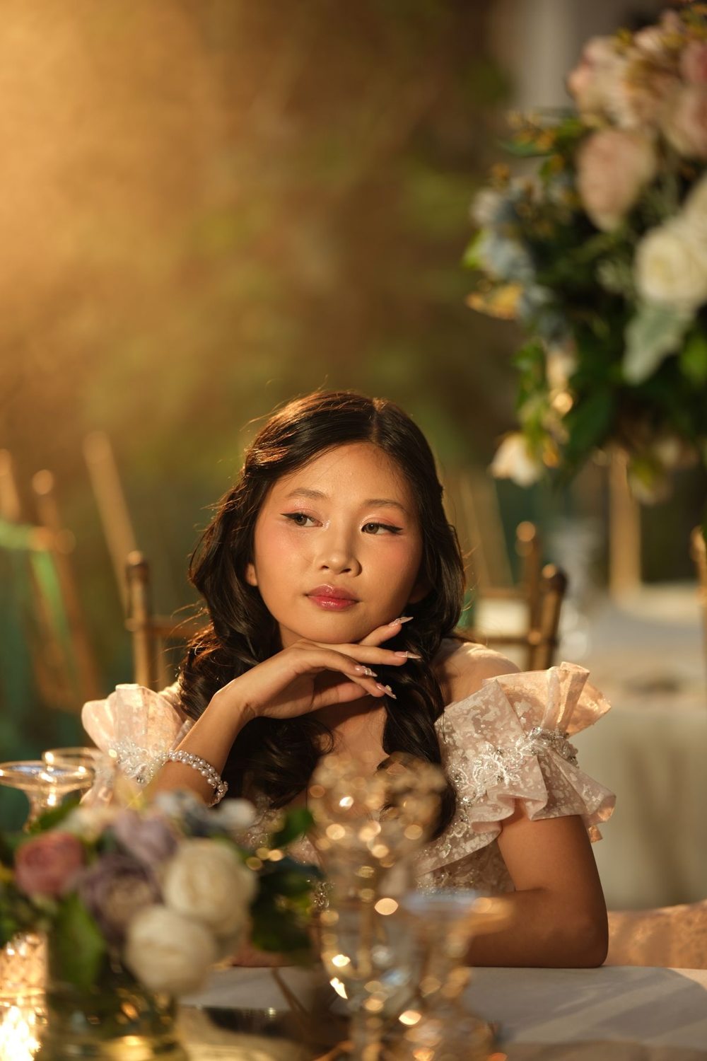 Woman in an occasion dress seated at a dinner table