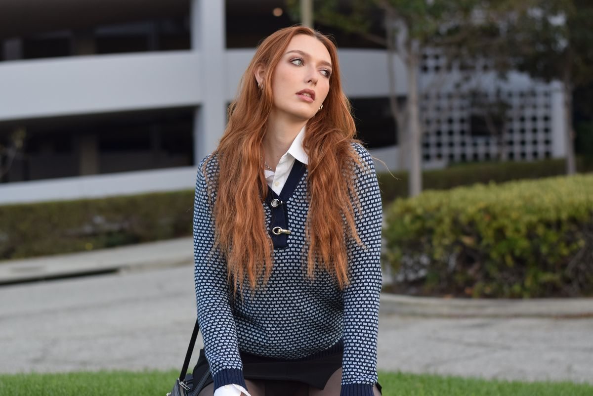 Blue sweater layered over a collared shirt