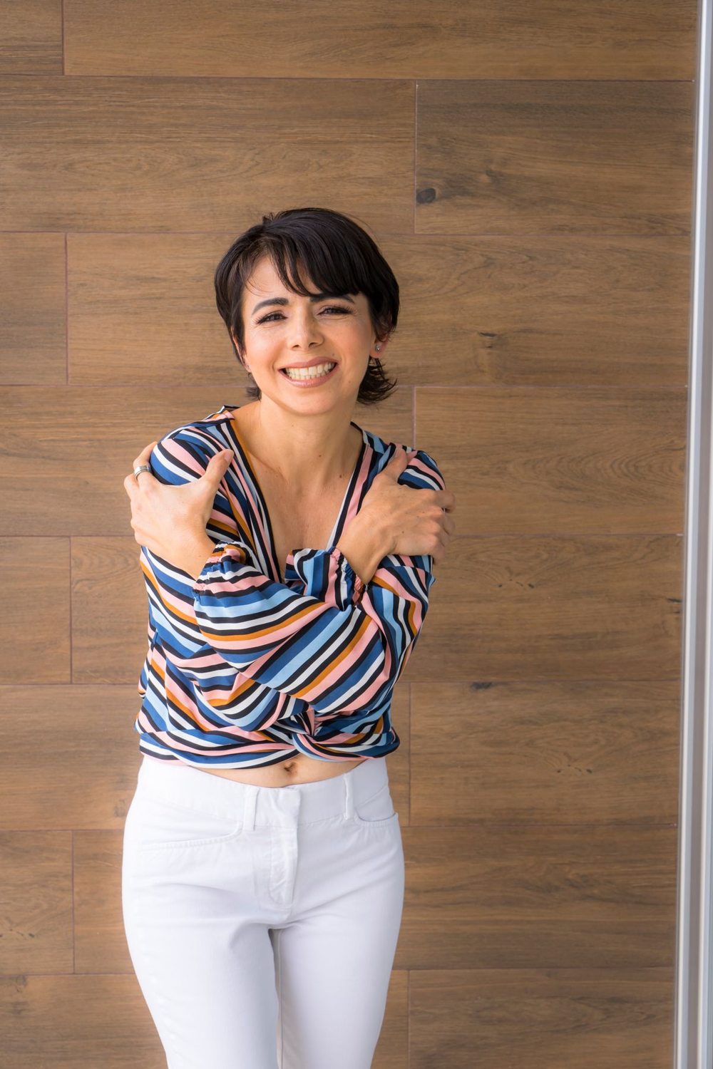 Striped long-sleeved top paired with white trousers