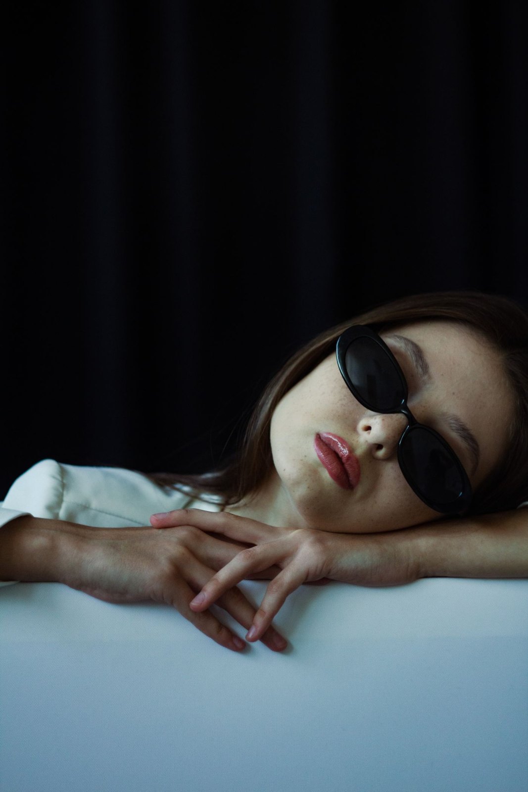 Close view of dark sunglasses resting on a woman’s face