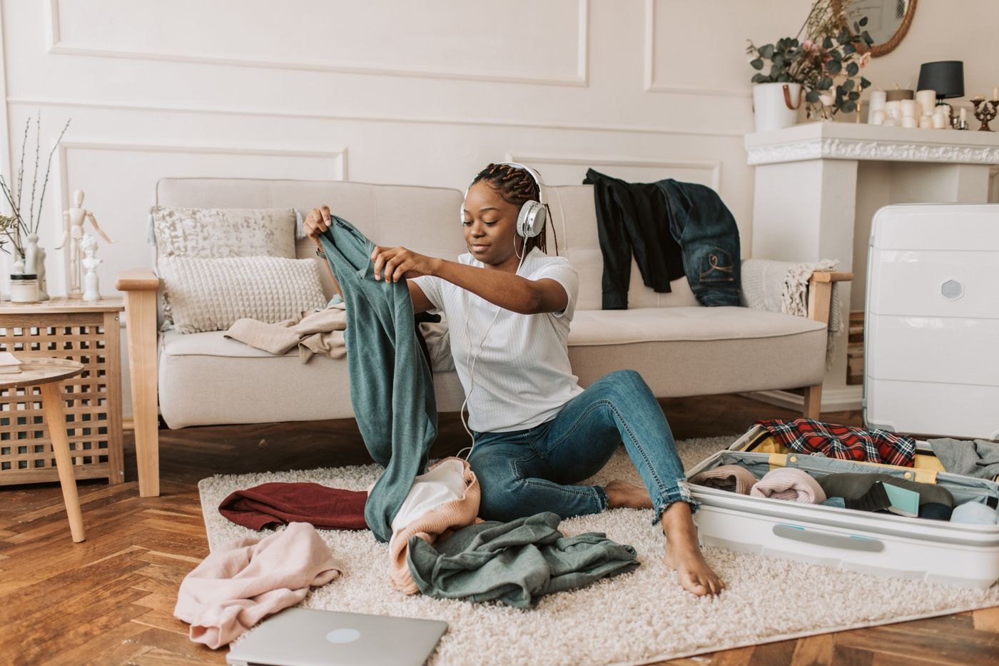 Woman arranging clothes in an open suitcase