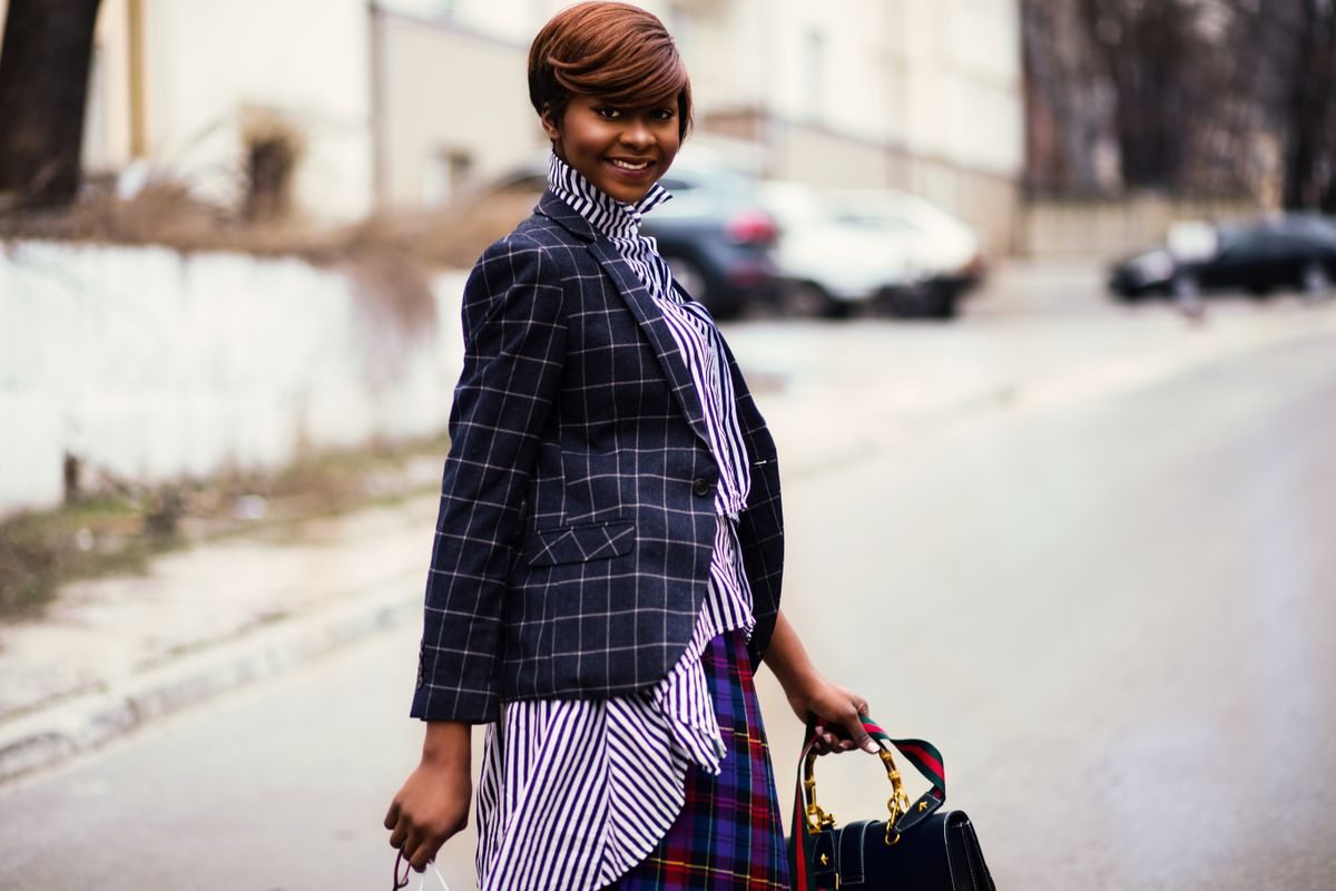Checked blazer worn over a striped top