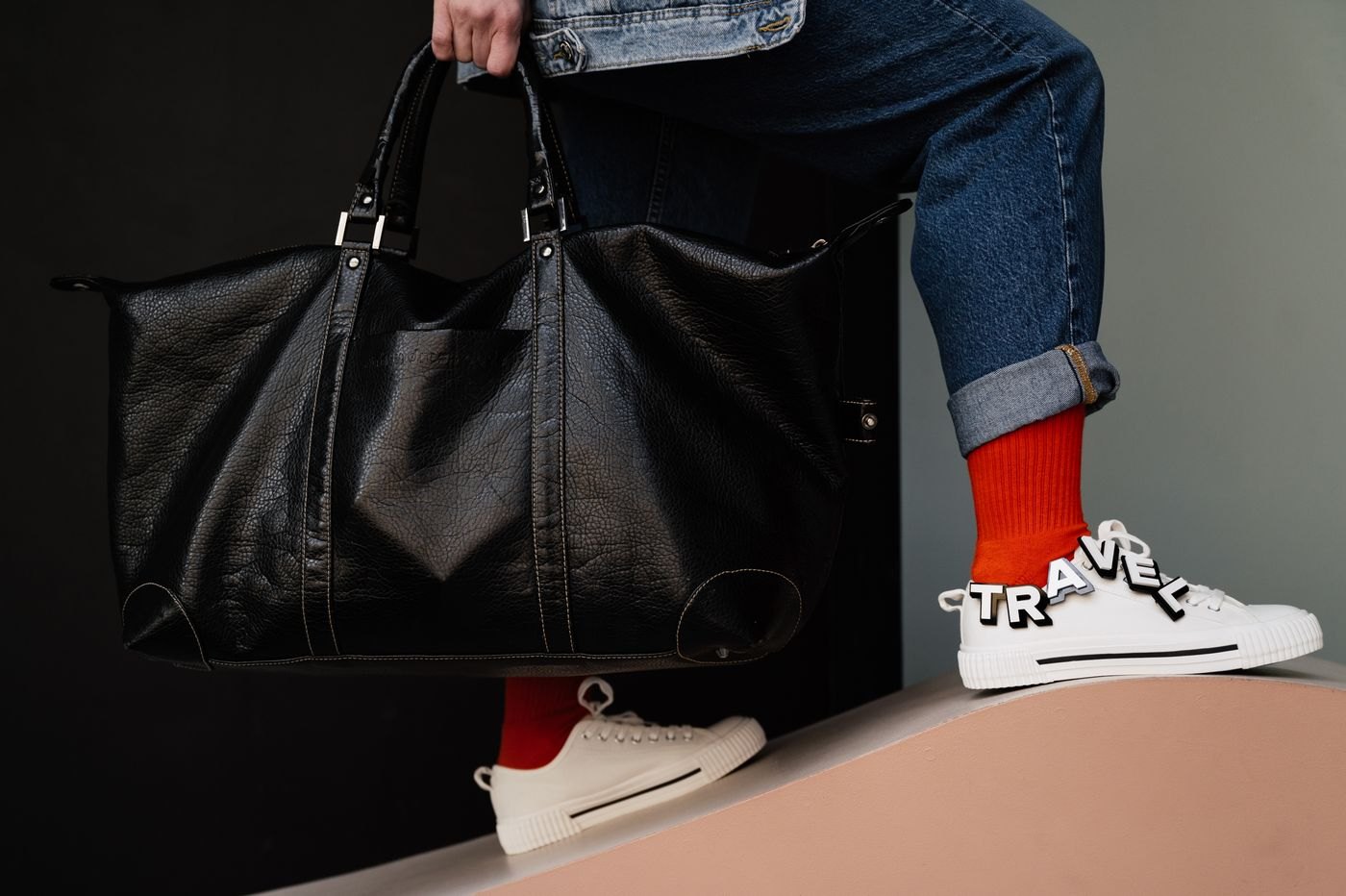 Person carrying a dark weekend holdall