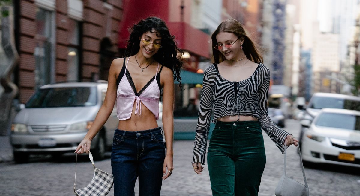 Two women walking together in casual city clothes